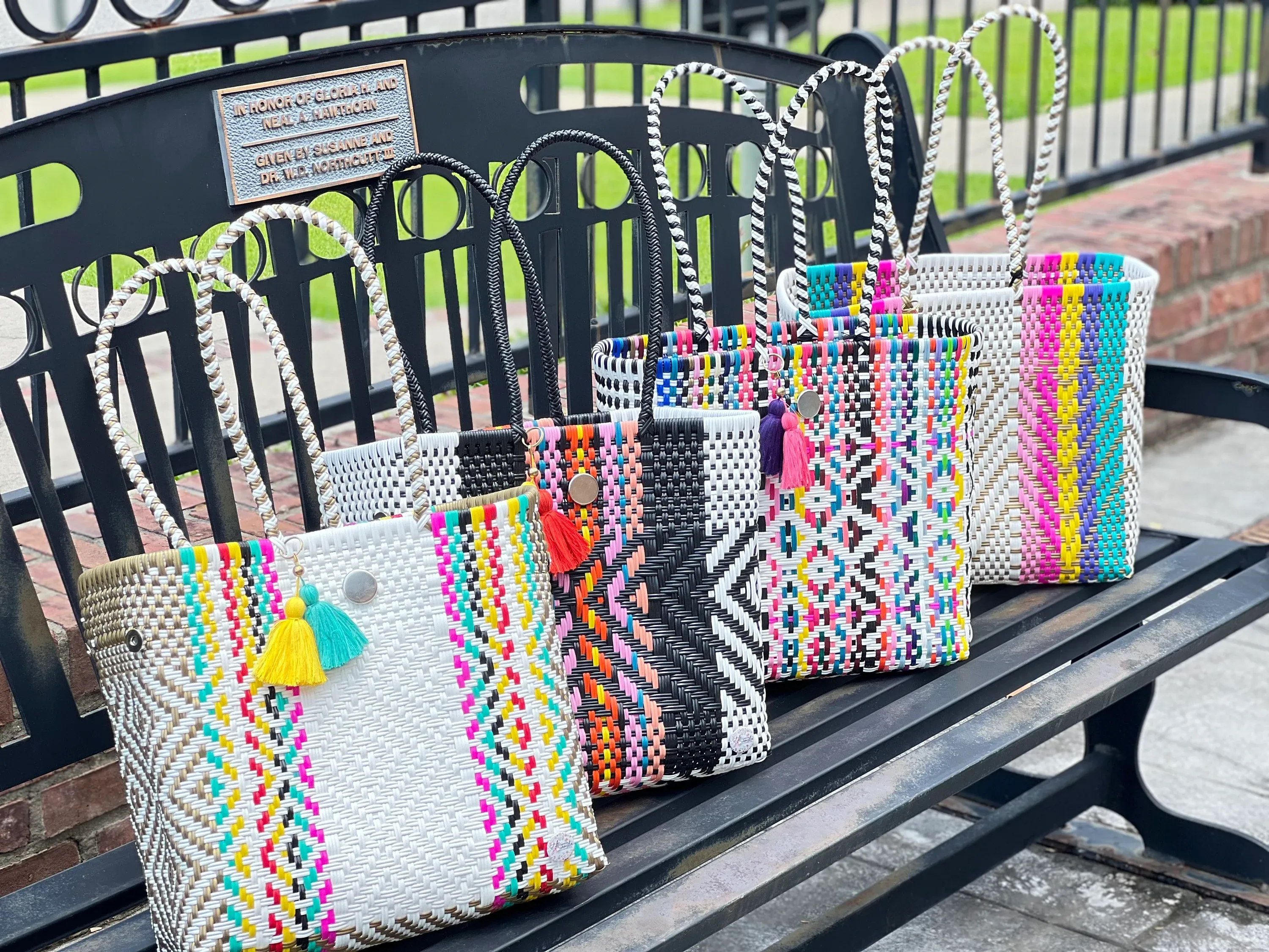 Handwoven tote bags with woven handles and tassel details